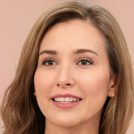 Joyful white young-adult female with long  brown hair and brown eyes