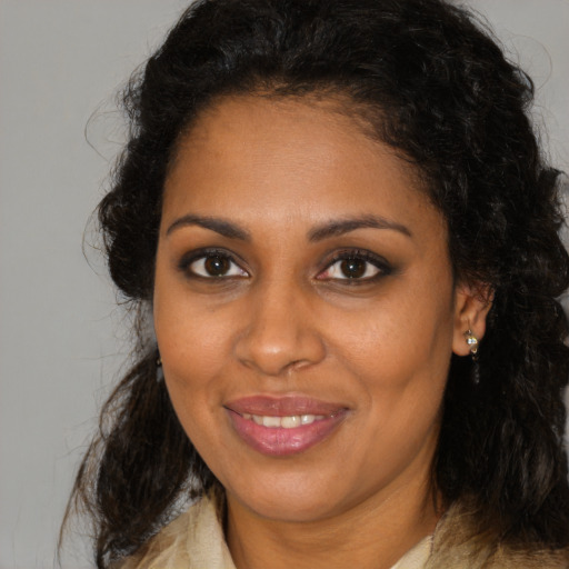 Joyful black young-adult female with medium  brown hair and brown eyes