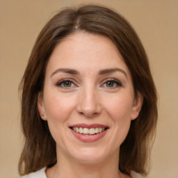 Joyful white adult female with medium  brown hair and brown eyes