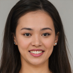 Joyful white young-adult female with long  brown hair and brown eyes