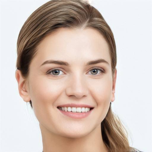 Joyful white young-adult female with long  brown hair and grey eyes