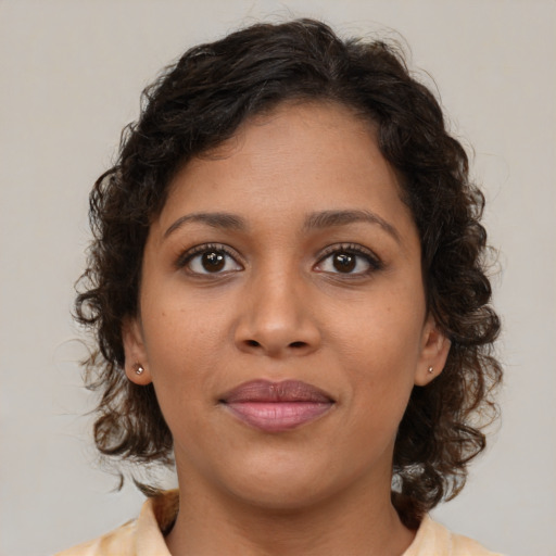 Joyful latino young-adult female with medium  brown hair and brown eyes