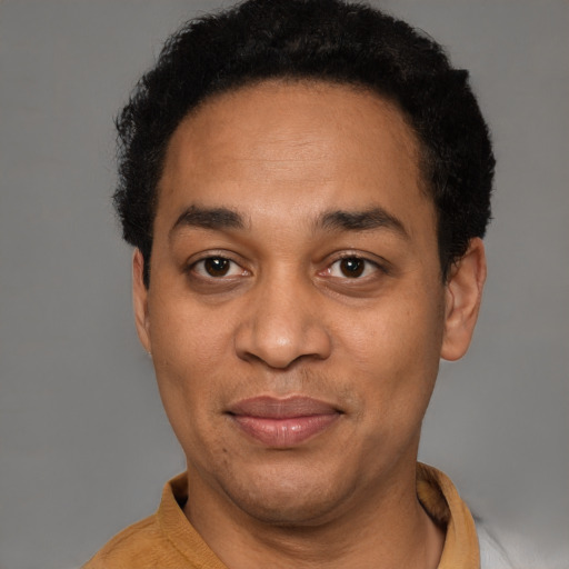 Joyful latino adult male with short  black hair and brown eyes