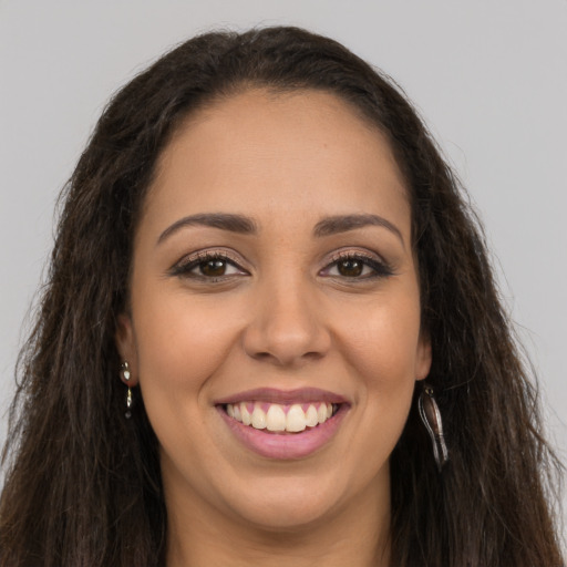 Joyful latino young-adult female with long  brown hair and brown eyes