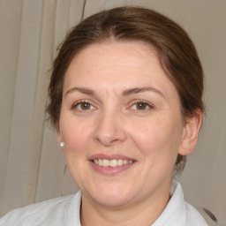 Joyful white adult female with medium  brown hair and brown eyes