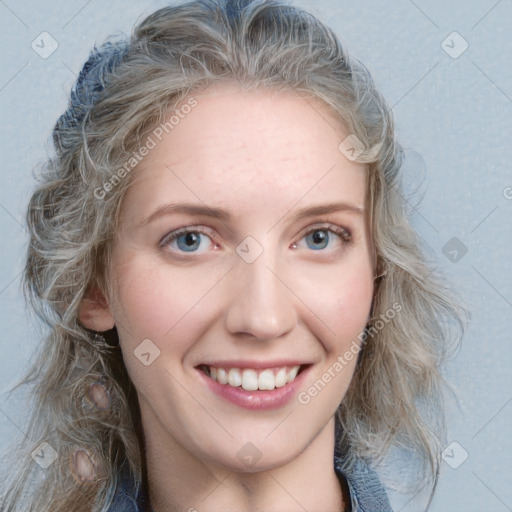 Joyful white young-adult female with long  brown hair and blue eyes