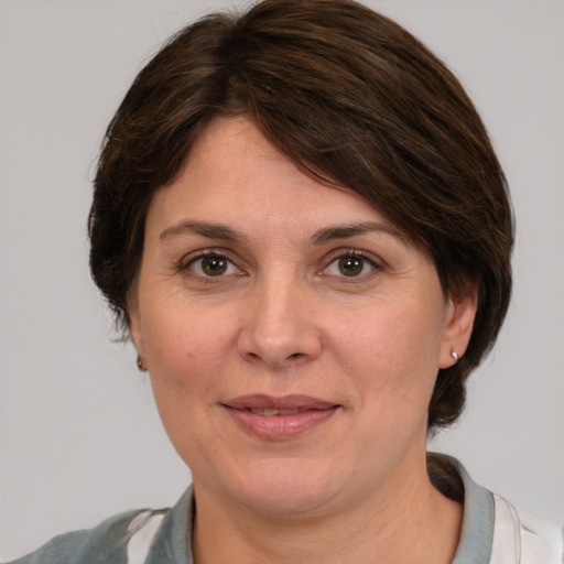 Joyful white adult female with medium  brown hair and grey eyes