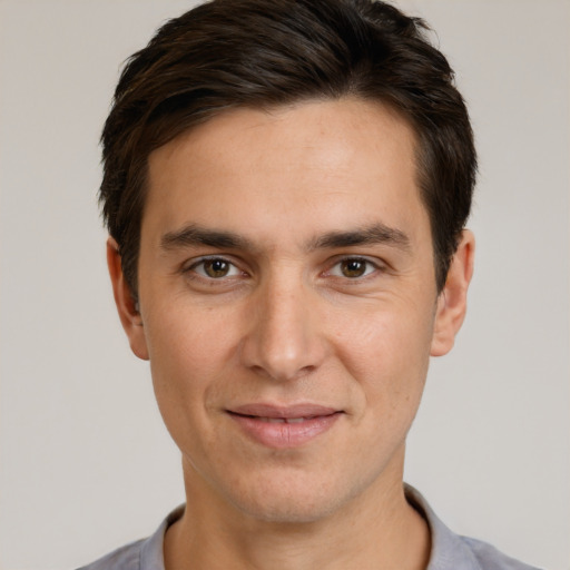 Joyful white young-adult male with short  brown hair and brown eyes