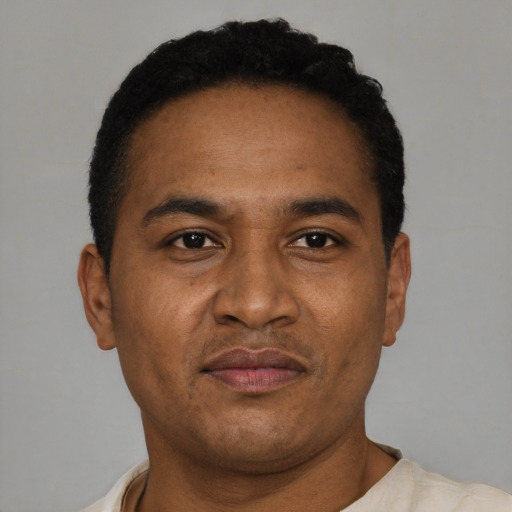 Joyful latino adult male with short  brown hair and brown eyes