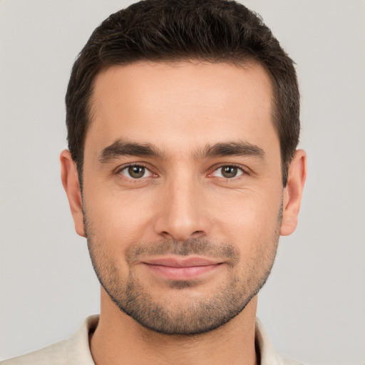 Joyful white young-adult male with short  brown hair and brown eyes