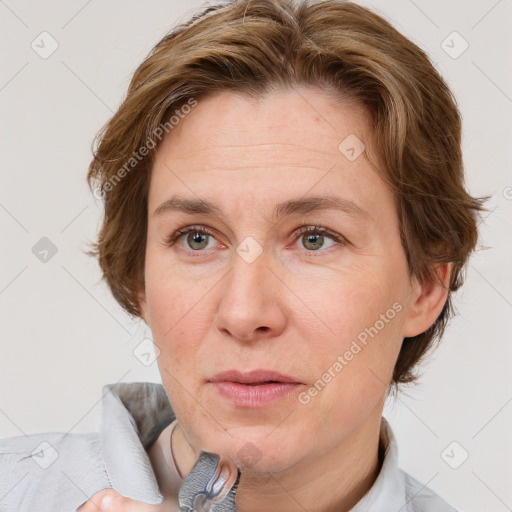 Joyful white adult female with short  brown hair and grey eyes