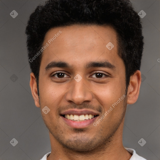 Joyful latino young-adult male with short  black hair and brown eyes