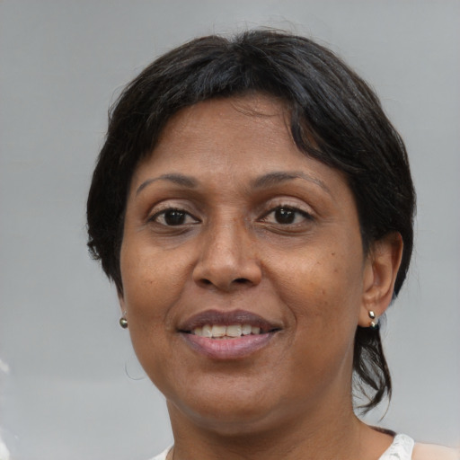 Joyful asian adult female with medium  brown hair and brown eyes