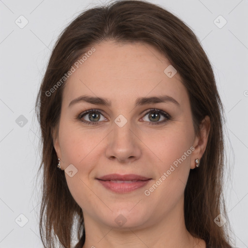 Joyful white young-adult female with long  brown hair and grey eyes