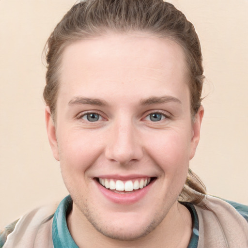 Joyful white young-adult female with short  brown hair and blue eyes