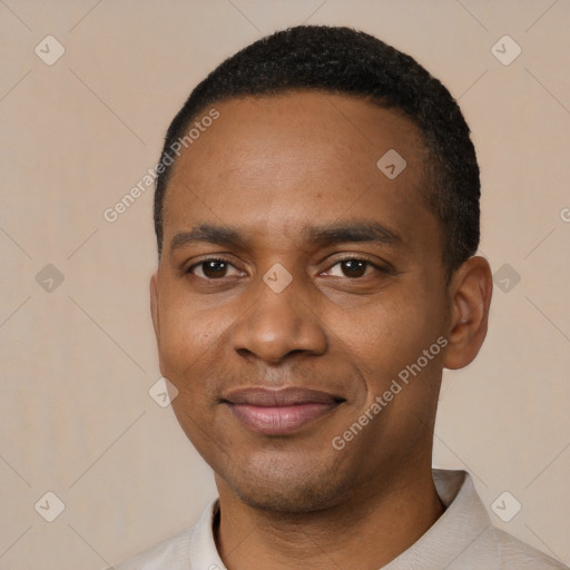 Joyful black young-adult male with short  black hair and brown eyes