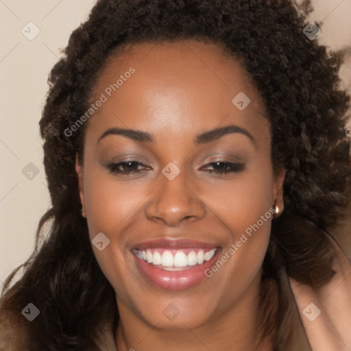 Joyful black young-adult female with long  brown hair and brown eyes