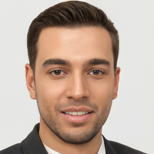 Joyful white young-adult male with short  brown hair and brown eyes