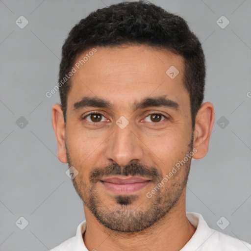 Joyful latino young-adult male with short  black hair and brown eyes
