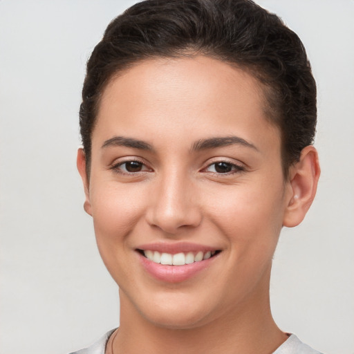 Joyful white young-adult female with short  brown hair and brown eyes