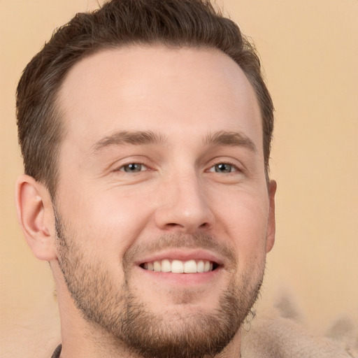 Joyful white young-adult male with short  brown hair and brown eyes