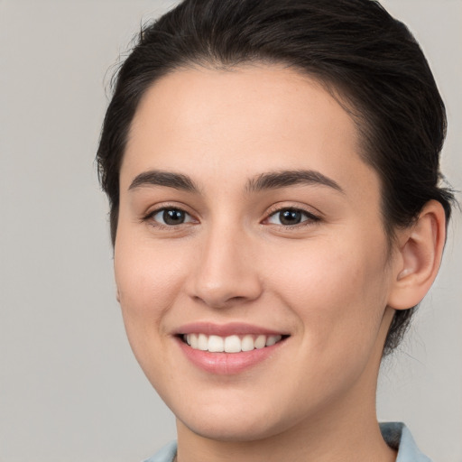 Joyful white young-adult female with medium  brown hair and brown eyes