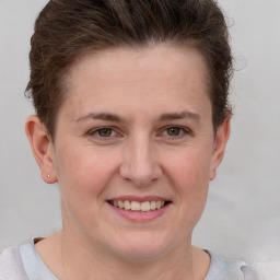 Joyful white young-adult female with short  brown hair and grey eyes