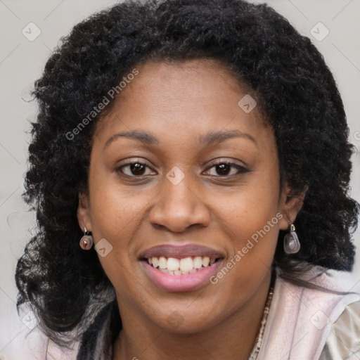 Joyful black young-adult female with long  brown hair and brown eyes