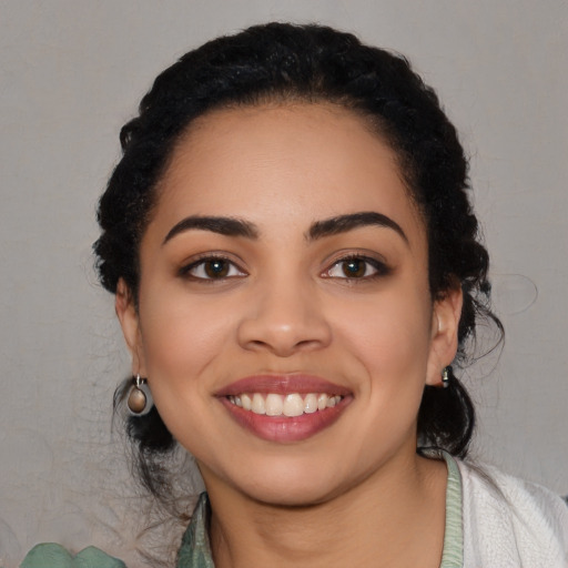 Joyful latino young-adult female with long  black hair and brown eyes