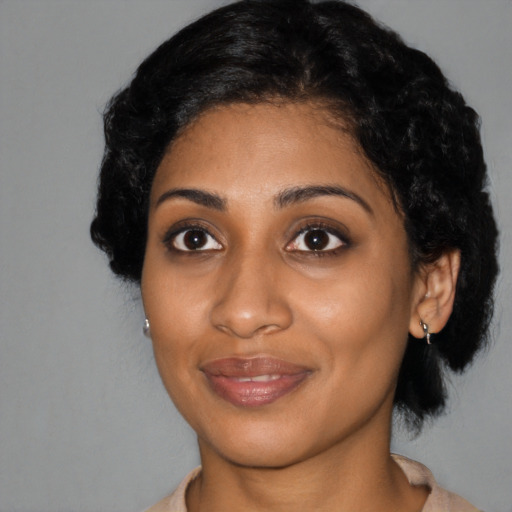 Joyful black young-adult female with medium  black hair and brown eyes