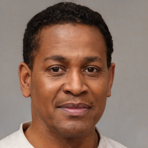 Joyful latino adult male with short  brown hair and brown eyes