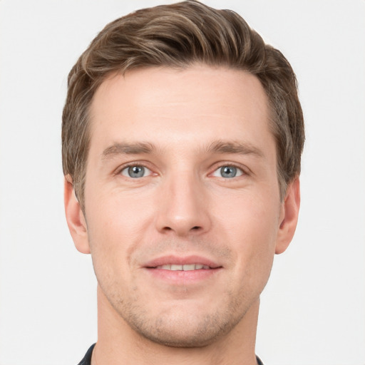 Joyful white young-adult male with short  brown hair and grey eyes