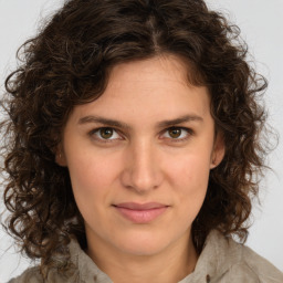 Joyful white young-adult female with medium  brown hair and green eyes