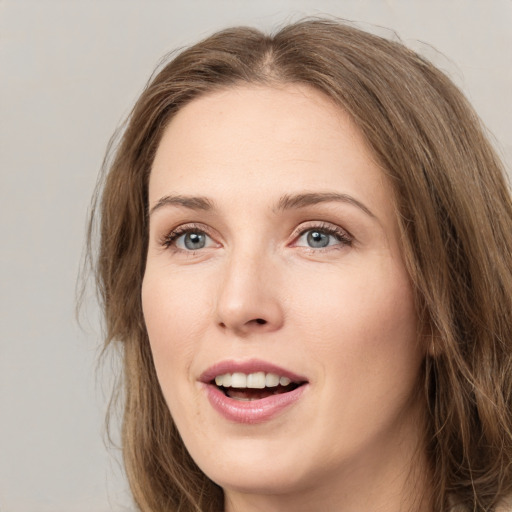 Joyful white young-adult female with long  brown hair and green eyes