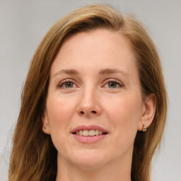 Joyful white young-adult female with medium  brown hair and green eyes