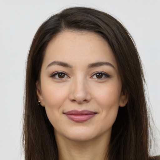 Joyful white young-adult female with long  brown hair and brown eyes