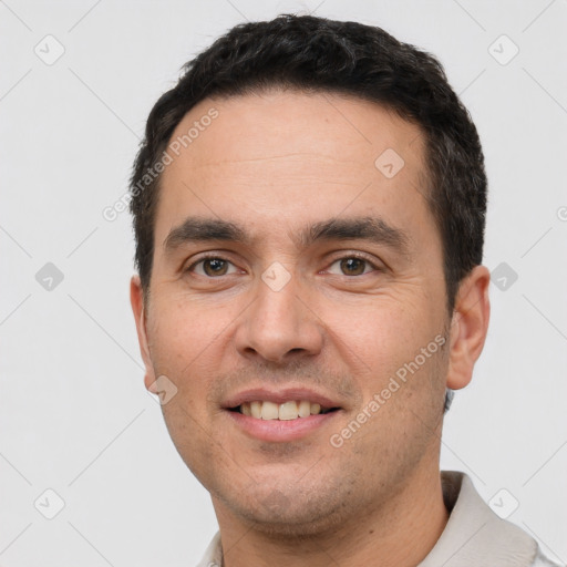 Joyful white young-adult male with short  black hair and brown eyes