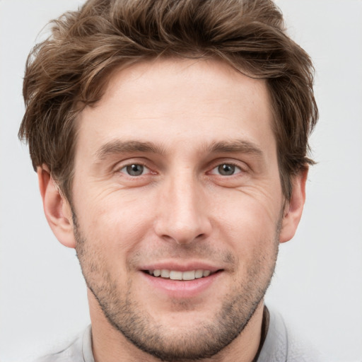 Joyful white adult male with short  brown hair and grey eyes