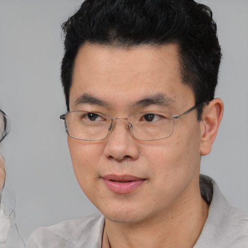 Neutral asian adult male with short  black hair and brown eyes