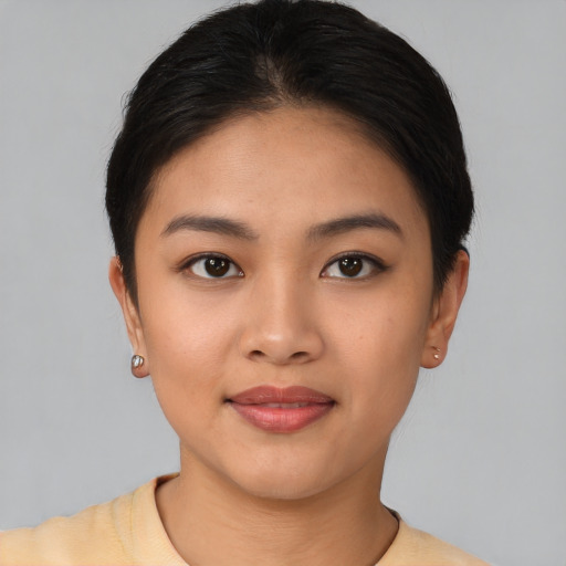 Joyful asian young-adult female with short  brown hair and brown eyes