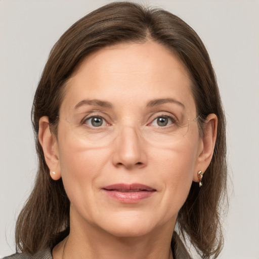 Joyful white adult female with medium  brown hair and grey eyes