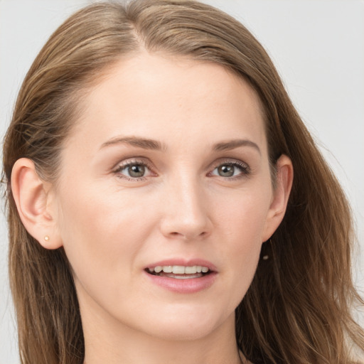 Joyful white young-adult female with long  brown hair and blue eyes