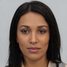 Joyful latino young-adult female with long  brown hair and brown eyes