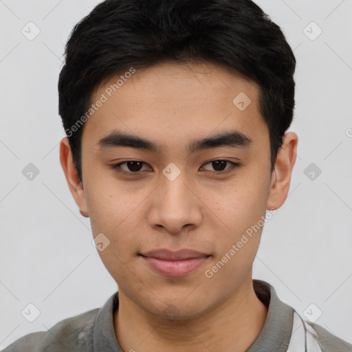 Joyful asian young-adult male with short  black hair and brown eyes