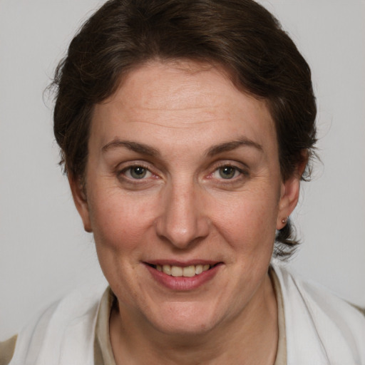 Joyful white adult female with short  brown hair and grey eyes