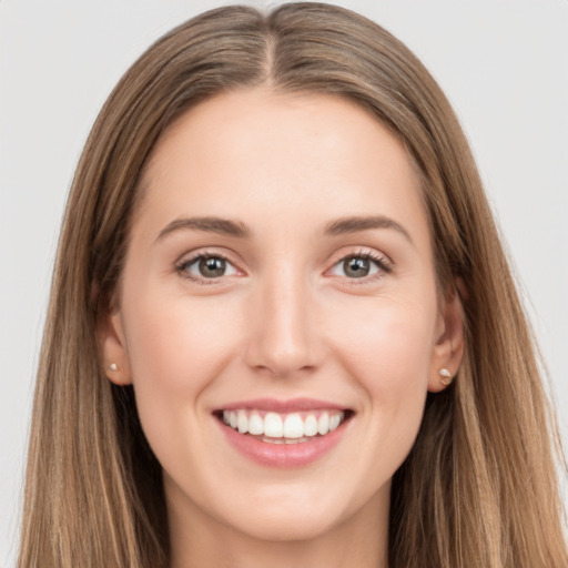 Joyful white young-adult female with long  brown hair and grey eyes