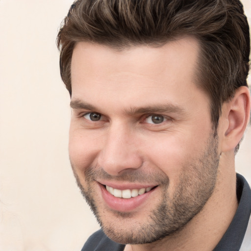 Joyful white young-adult male with short  brown hair and brown eyes