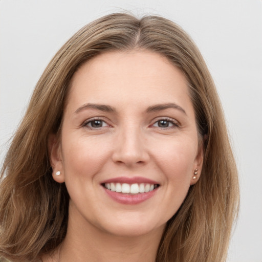 Joyful white young-adult female with long  brown hair and grey eyes