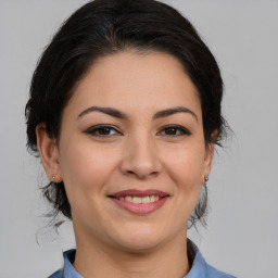 Joyful asian young-adult female with medium  brown hair and brown eyes