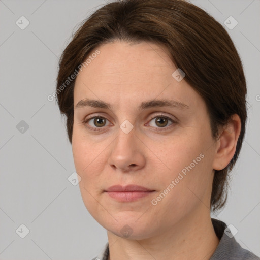 Joyful white adult female with medium  brown hair and grey eyes